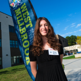  West Milkbrook Magnet Middle student poses outside of the school at ribbon cutting ceremony